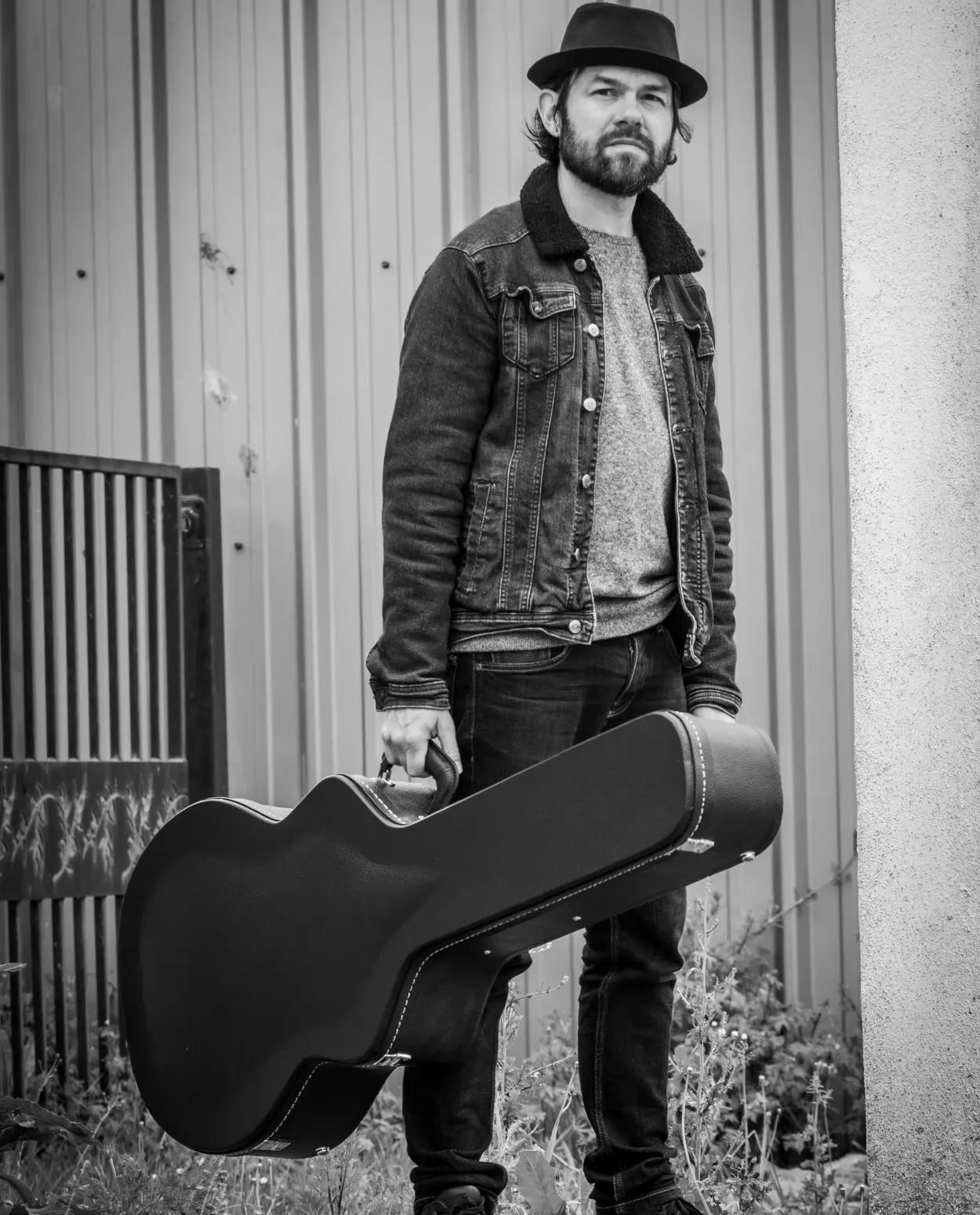 Man with a guitar case